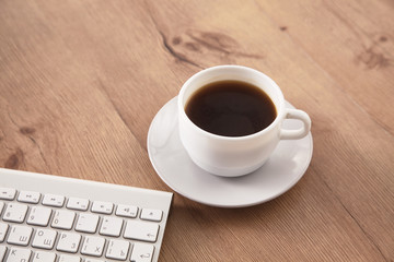 Obraz na płótnie Canvas A cup of coffee on the office table