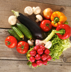 Composition with assorted raw organic vegetables wooden table