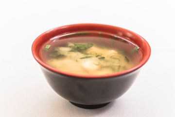 Black and red bowl with missoshiro on white background