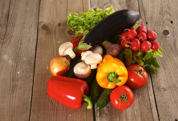 Composition with assorted raw organic vegetables wooden table