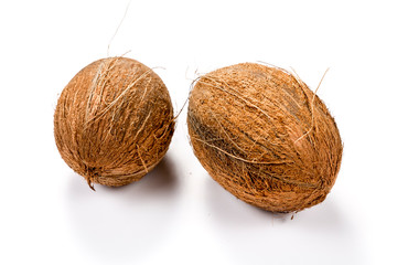 Two raw coconuts isolated on white background