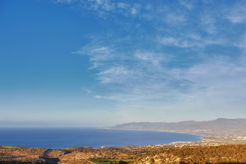 Obraz premium Looking across a campsite towards Chrysohou Bay, Laatchi, Polis and the Akamas Peninsula, Paphos, Cyprus.