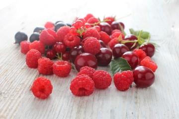 Ripe raspberries in the garden. Fresh juicy red berries on a wooden table. Tasty and healthy food. Healthy lifestyle.