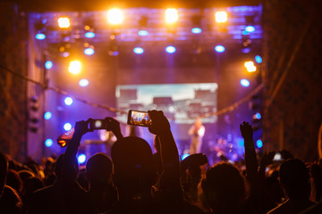 People at concert shooting video or photo.