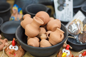 Bowl with a handful of small clay jugs