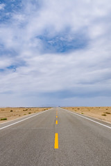 Road leading to horizon in gobi desert near Dunhuang, Gansu, in northwestern China