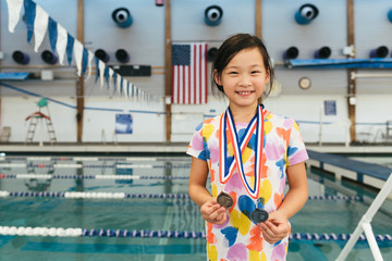 Young girl proud of her medals that she won