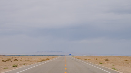 Road leading to horizon in gobi desert near Dunhuang, Gansu, in northwestern China