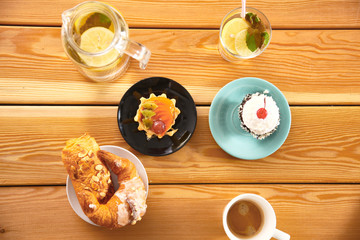 cakes and drinks on a wooden table