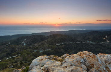 Sun setting behind Mediterranean sea at Akamas, Cyprus.