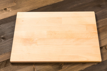 Empty cutting board isolated on wooden surface