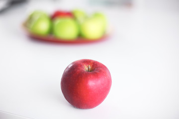 wooden plate with ripe fresh red and green apples