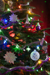 decorated christmas tree with lights on red background