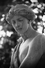 The goddess of love in Greek mythology, Aphrodite (Venus in Roman mythology) Fragment of ancient statue. Black and white photo.