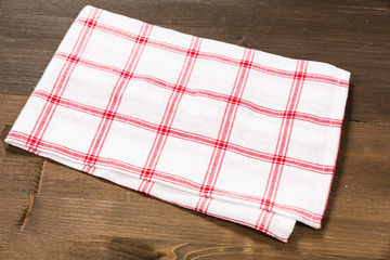 Checkered tablecloth isolated on wooden background