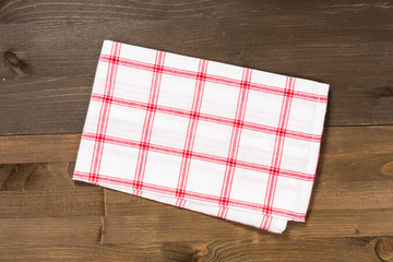 Checkered tablecloth isolated on wooden background