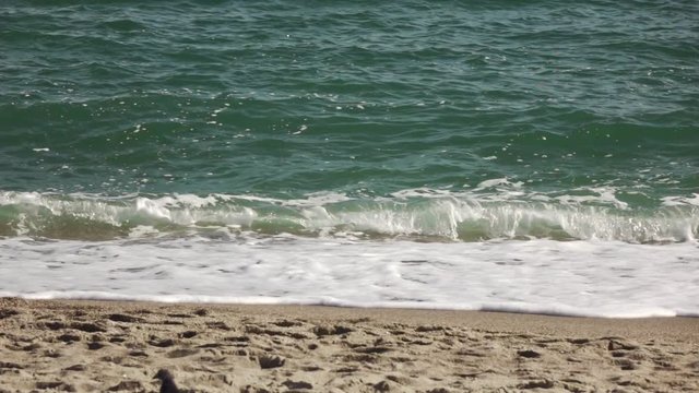 Great panoramic seascape scenic with large wave crashing on sandy shore. Slow motion, Full HD video, 240fps, 1080p.