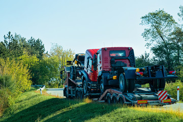 Truck transporter carrying new lorries in road in Slovenia
