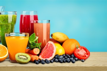 Tasty fruits  and juice with vitamins on background