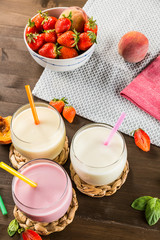 Colorful milkshakes on a wooden table