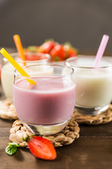 Colorful milkshakes on a wooden table