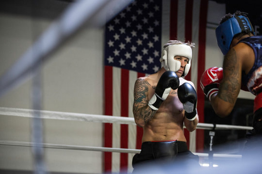 Boxers fighting in boxing ring