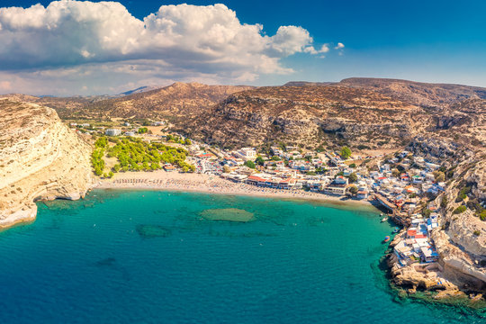 Aerial view of Matala beach on Crete island with azure clear water, Greece, Europe