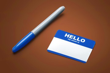 Blue Hello My Name Is Tag and pen on table with Copy Space,