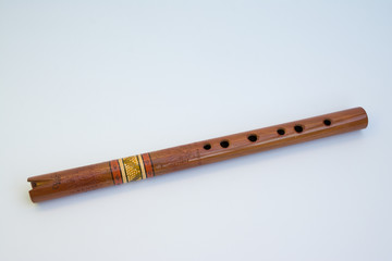 Old Quena of Peru (traditional flute of the Andes), with 37 notes and three octaves, 37 cm long. It consists of a tube with a simple notch, has six front holes, one back. Isolated on white background.