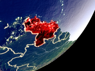 Venezuela from space on model of Earth at night. Very fine detail of the plastic planet surface and visible bright city lights.