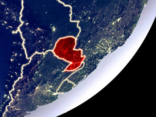 Paraguay from space on model of Earth at night. Very fine detail of the plastic planet surface and visible bright city lights.