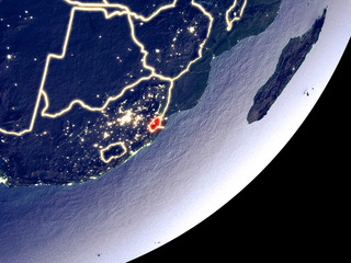 eSwatini from space on model of Earth at night. Very fine detail of the plastic planet surface and visible bright city lights.
