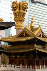 detail of a temple decoration showing three lions on a pillar