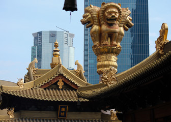 detail of a temple decoration showing three lions on a pillar