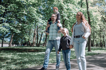 family enjoys a walk in the city Park.