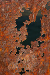 Rusty iron sheet. Fatal oxidation of metal. A dead ship destroyed by the sea.