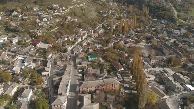 Aerial view of the city, houses and roads with trees. Shot. Urban landscape