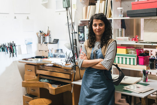 Portrait of smiling artisan standing in workshop