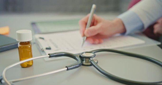 Medical Professional Writing RX Prescription By Stethoscope 4K