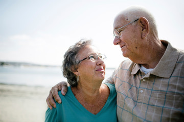 Smiling senior couple standing on beach