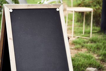 A Small Blackboard Standing Outside