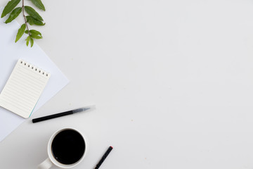 White office desk with notebook and pen