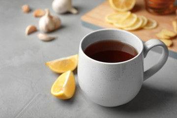 Cup of hot tea as natural cough remedy on table