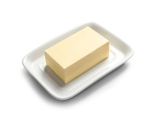 Ceramic dish with block of fresh butter on white background