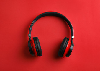 Fototapeta na wymiar Wireless headphones on color background, top view