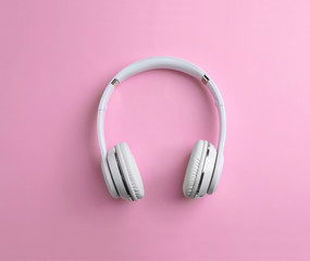 Wireless headphones on color background, top view