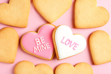 Decorated heart shaped cookies on color background, top view. Valentine's day treat