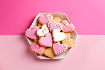 Plate with decorated heart shaped cookies on color background, top view. Valentine's day treat