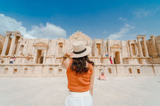 Back view of Asian young woman standing in front of South roman theatre, Jerash, Jordan