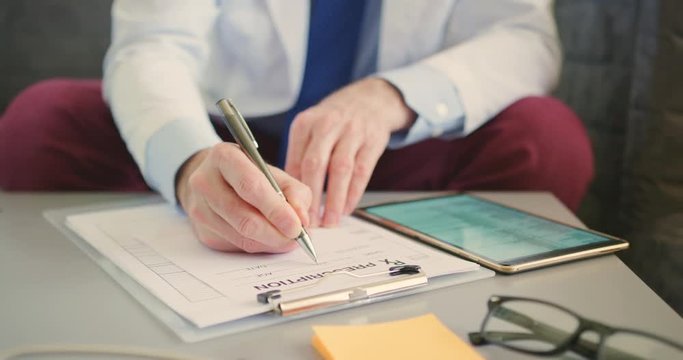 Doctor Writing RX Prescription While Sitting On Sofa 4K